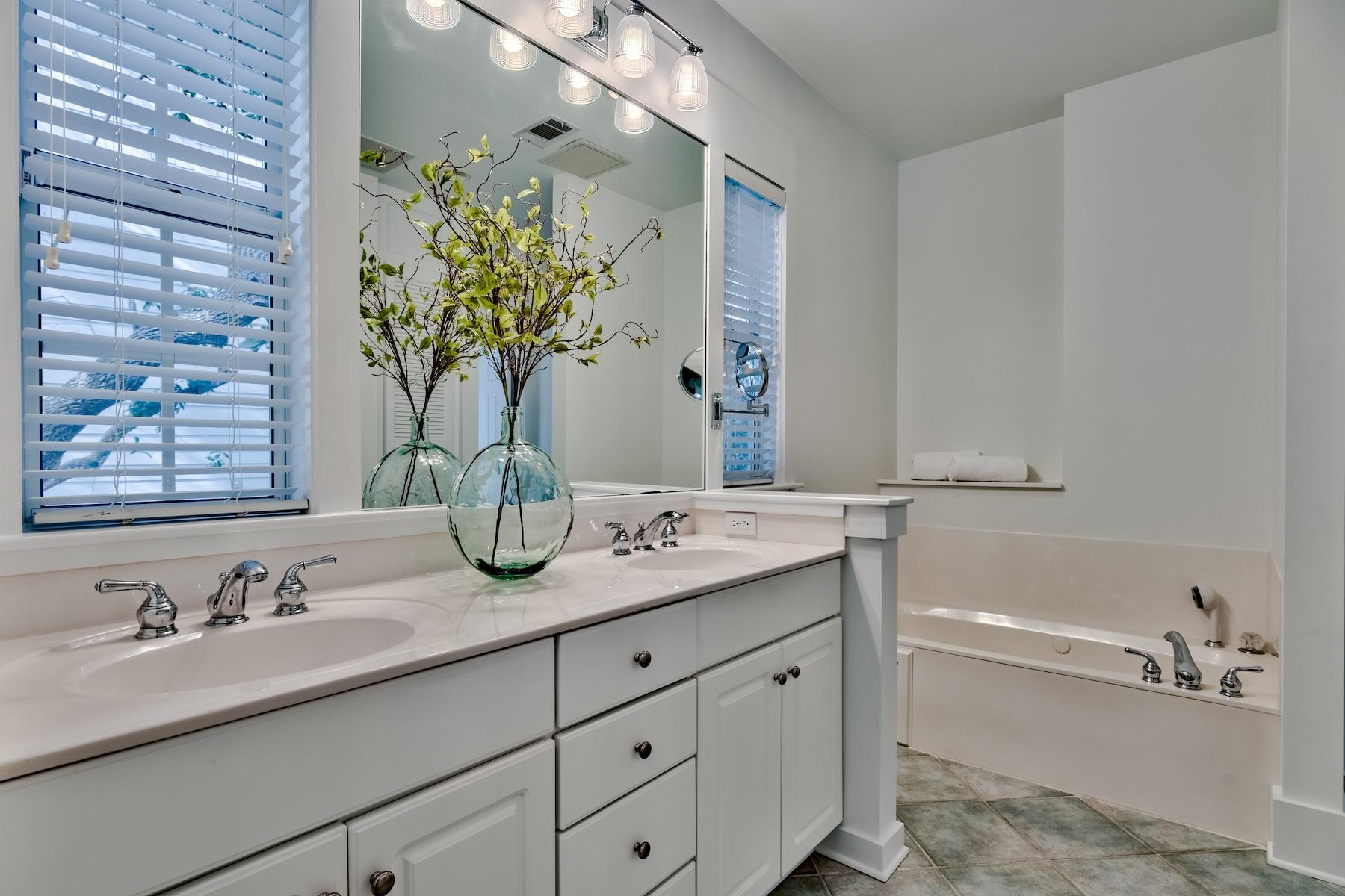 149 East Grove Avenue Santa Rosa Beach, FL 32459 - Photo 15 of 42 a bathroom with a granite countertop sink a large mirror and vanity
