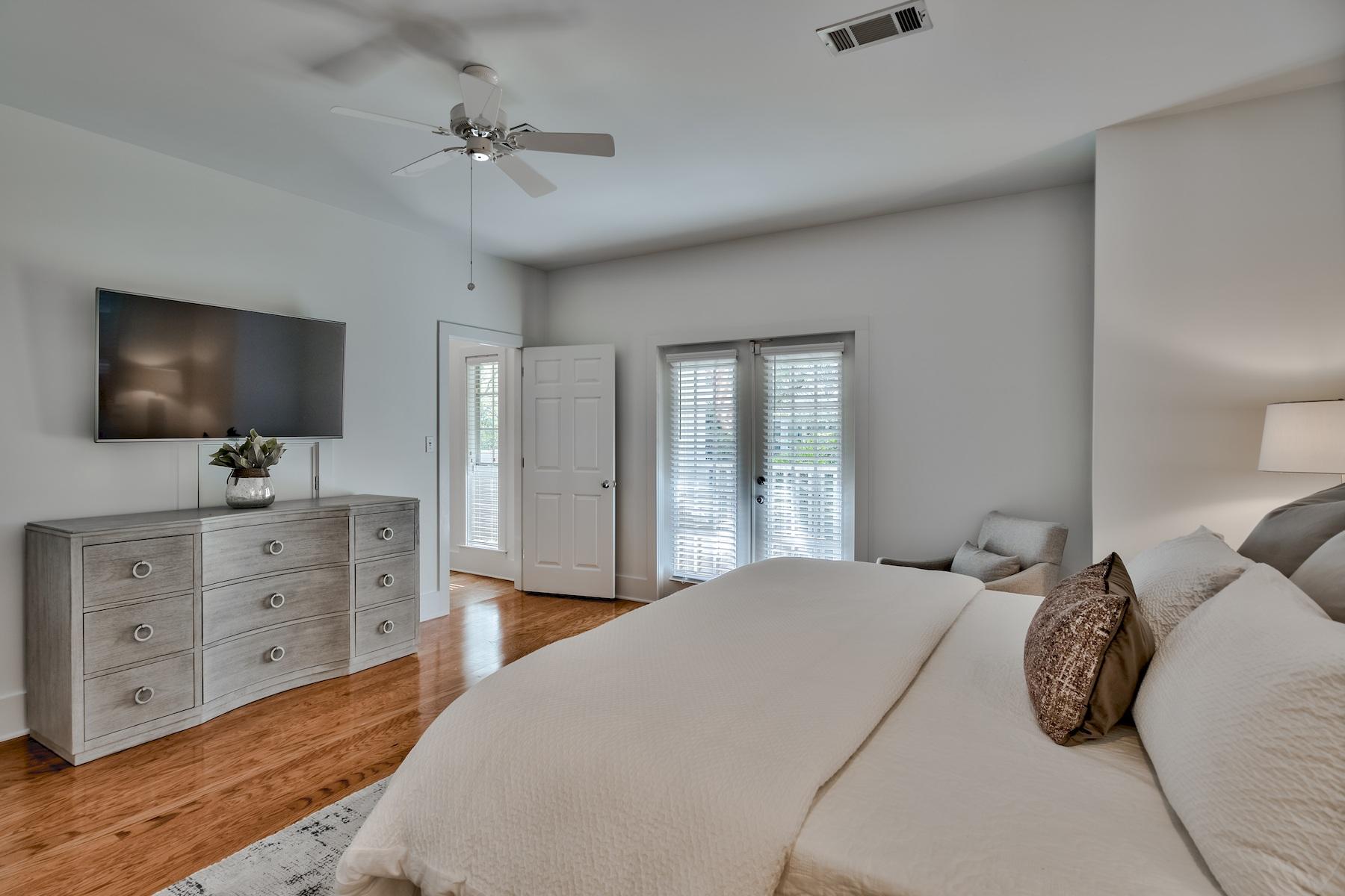 149 East Grove Avenue Santa Rosa Beach, FL 32459 - Photo 16 of 42 a bedroom with a large bed and a flat tv screen on dresser