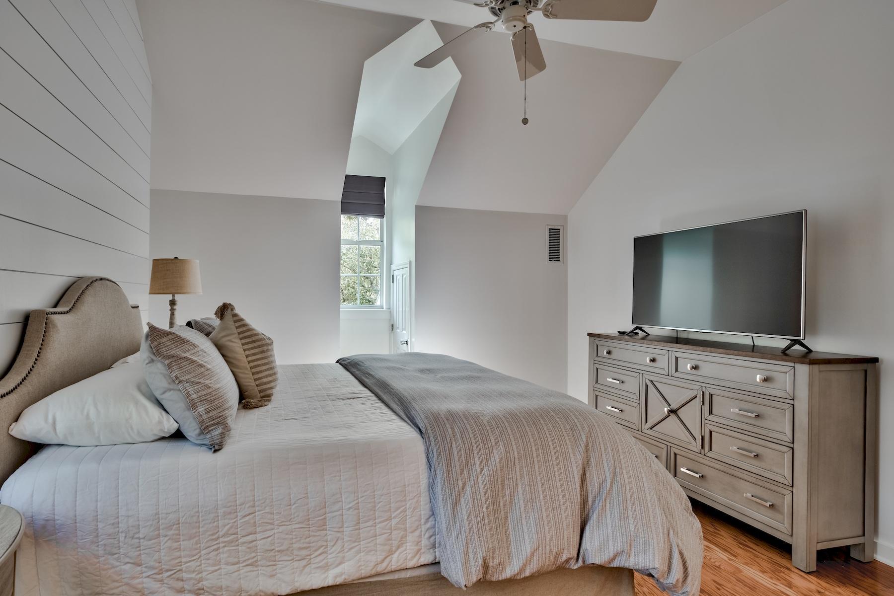 149 East Grove Avenue Santa Rosa Beach, FL 32459 - Photo 18 of 42 a bedroom with a bed and a flat tv screen on dresser