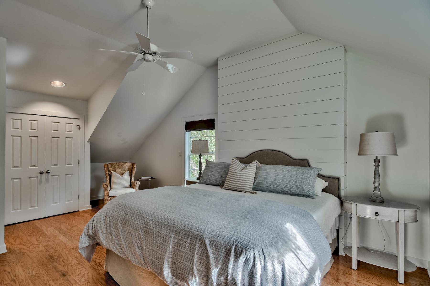 149 East Grove Avenue Santa Rosa Beach, FL 32459 - Photo 19 of 42 a bedroom with a bed and a chandelier