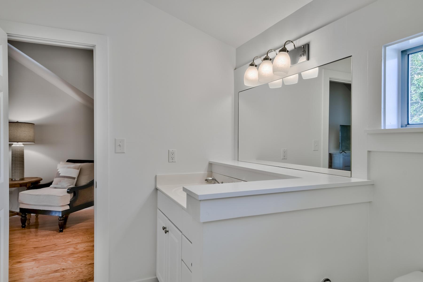 149 East Grove Avenue Santa Rosa Beach, FL 32459 - Photo 25 of 42 a bathroom with a sink and a mirror