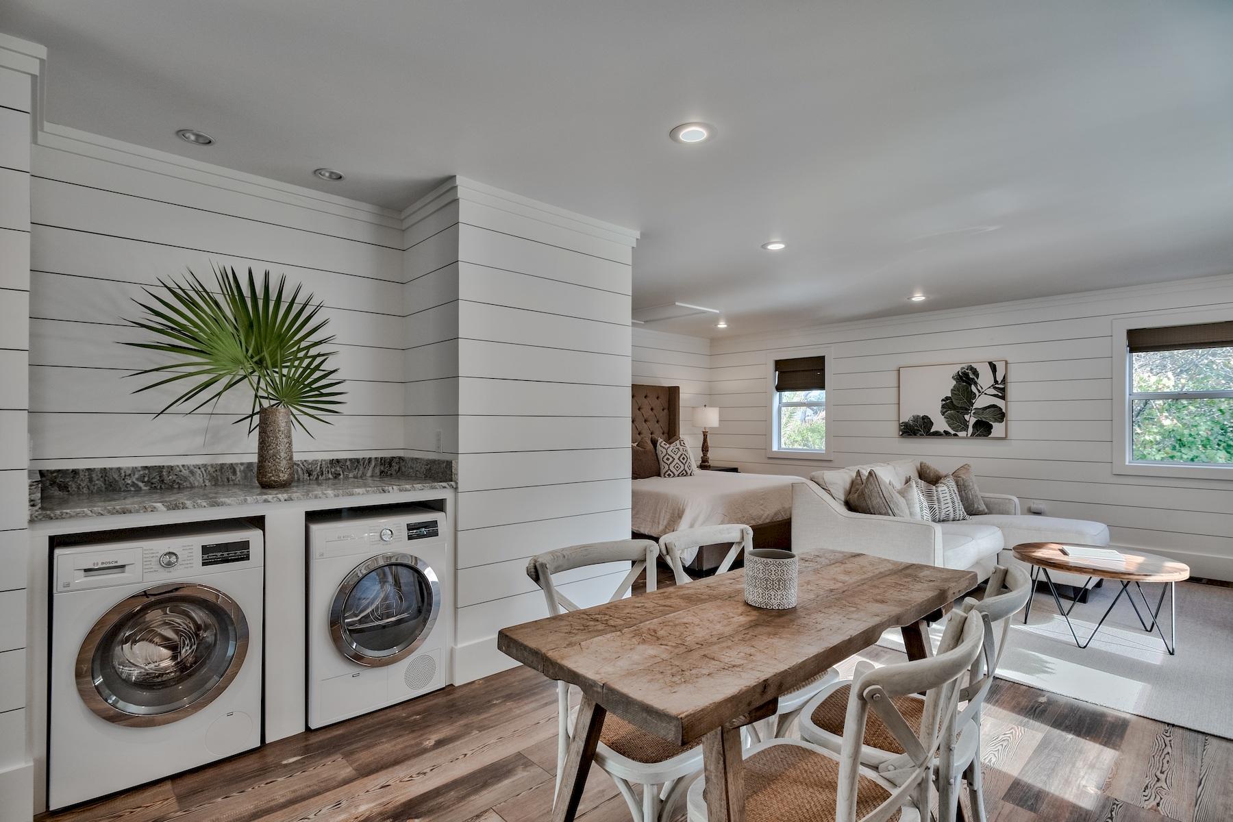149 East Grove Avenue Santa Rosa Beach, FL 32459 - Photo 37 of 42 a living room with a table chairs and a kitchen view
