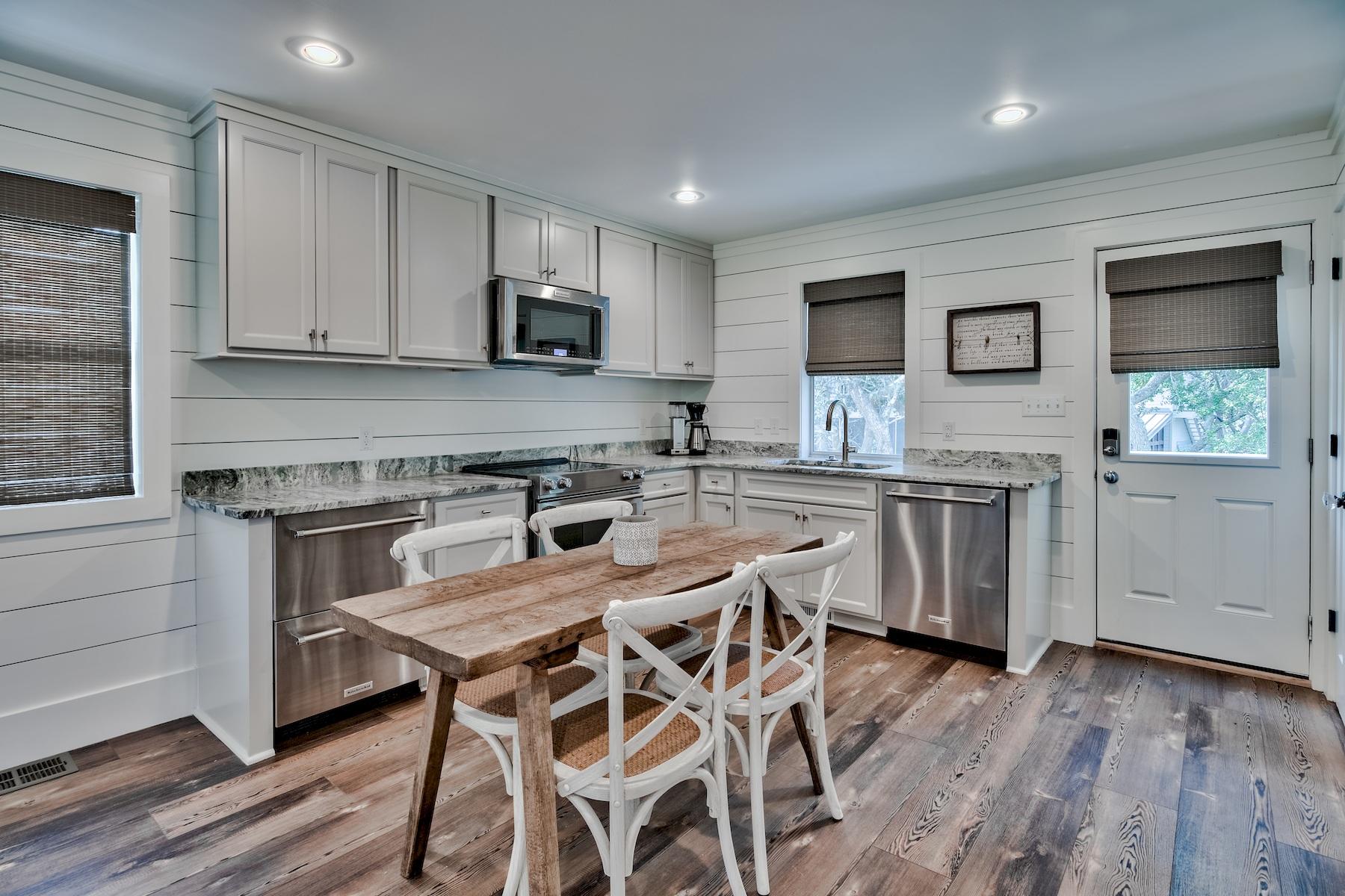 149 East Grove Avenue Santa Rosa Beach, FL 32459 - Photo 38 of 42 a kitchen with granite countertop white cabinets and stainless steel appliances
