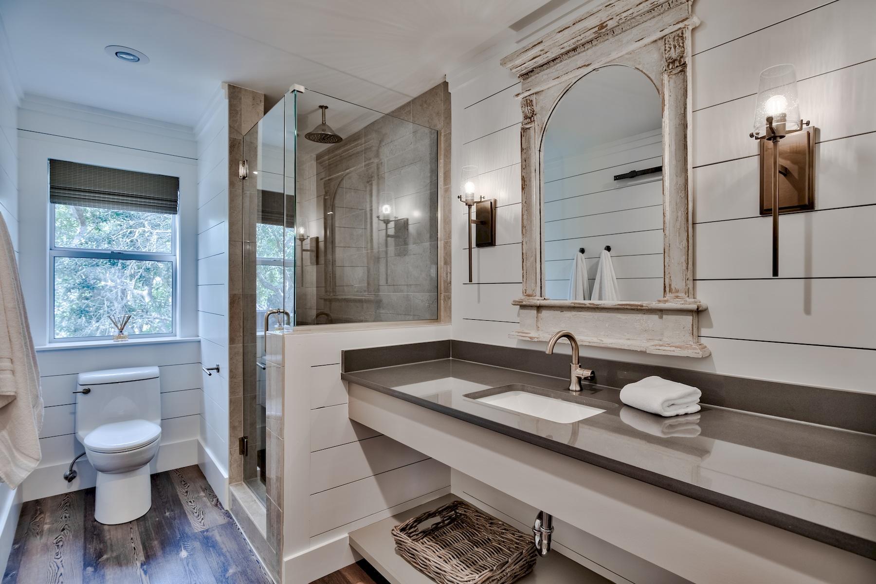 149 East Grove Avenue Santa Rosa Beach, FL 32459 - Photo 39 of 42 a bathroom with a granite countertop sink a toilet a mirror and shower