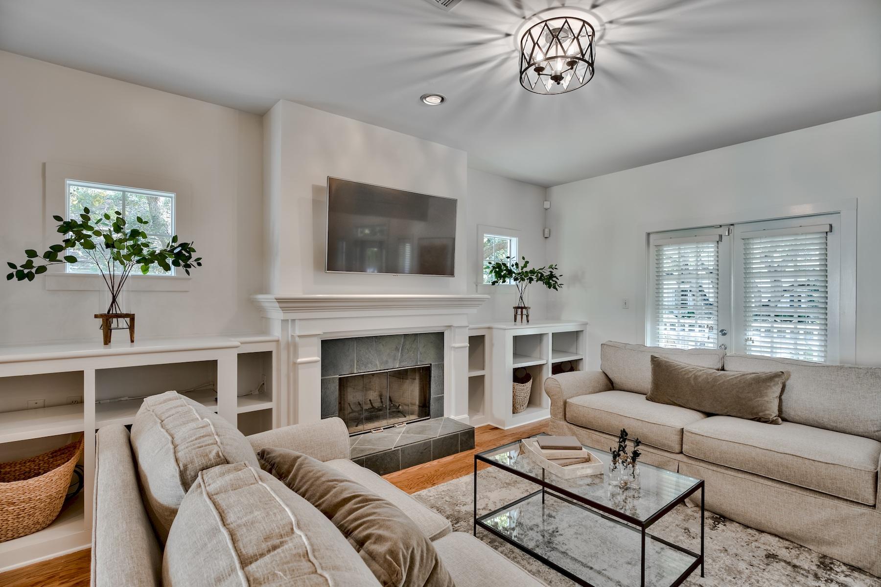 149 East Grove Avenue Santa Rosa Beach, FL 32459 - Photo 4 of 42 a living room with furniture a fireplace and a flat screen tv