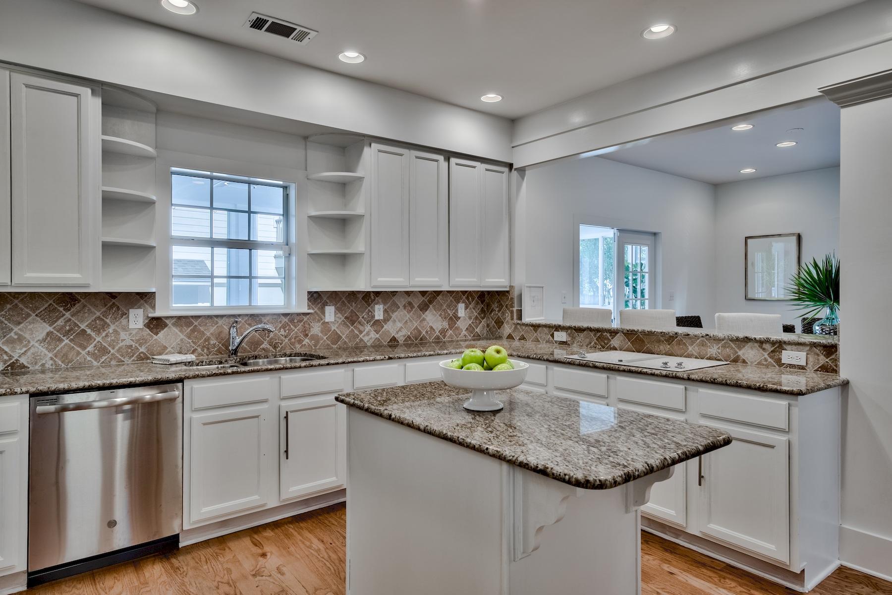 149 East Grove Avenue Santa Rosa Beach, FL 32459 - Photo 8 of 42 a kitchen with stainless steel appliances granite countertop a sink and cabinets
