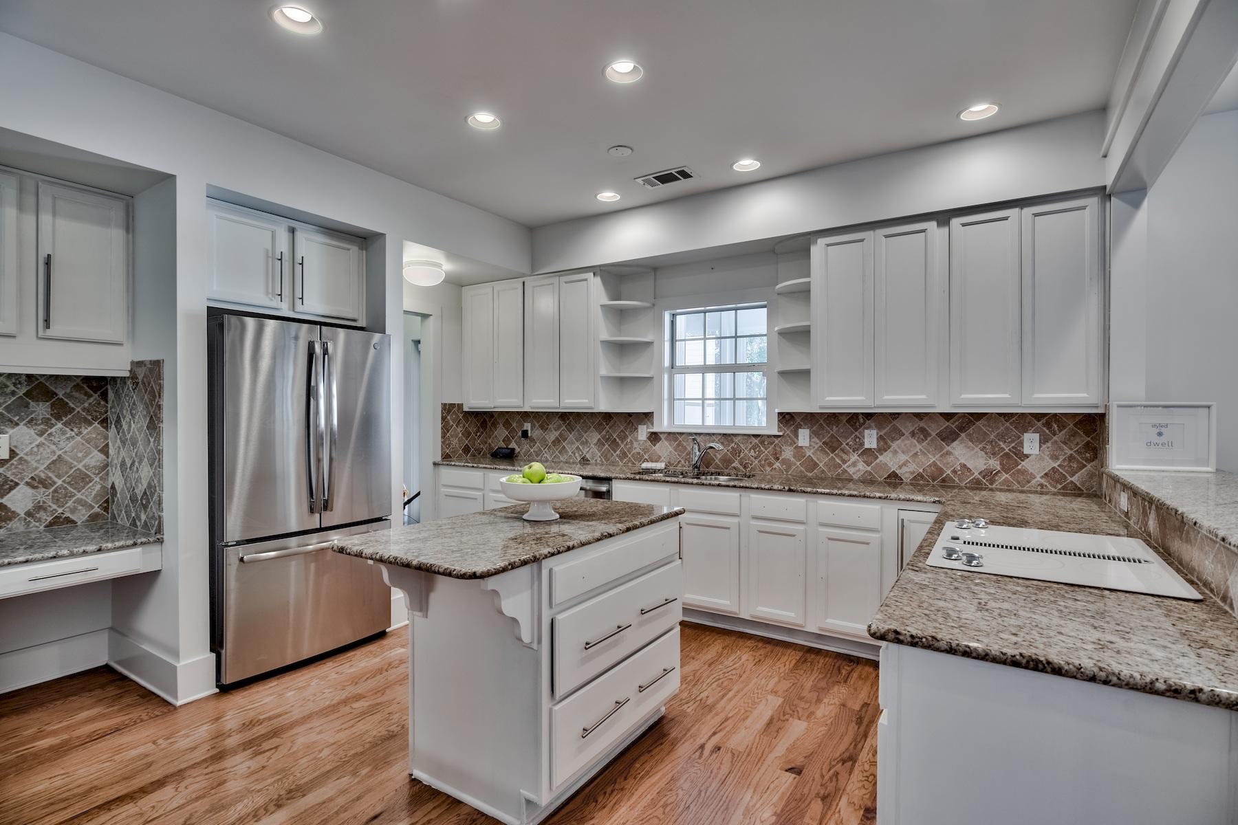 149 East Grove Avenue Santa Rosa Beach, FL 32459 - Photo 9 of 42 a kitchen with a refrigerator sink and cabinets