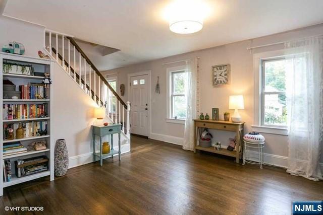 a view of a livingroom with furniture and hardwood floor
