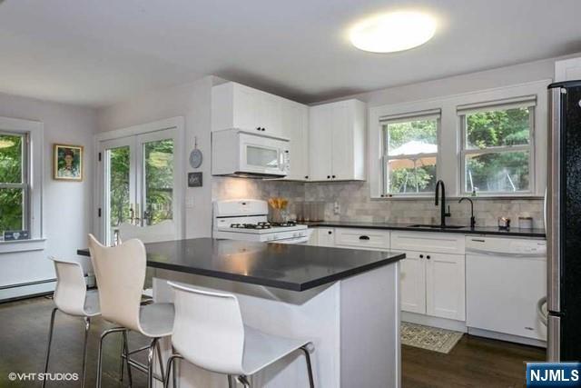 24 Robinhood Avenue Closter, NJ 07624 - Photo 6 of 20 a kitchen with kitchen island granite countertop a sink cabinets and window