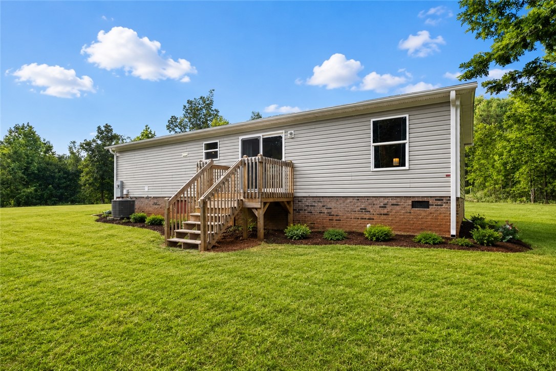 101 Drucker Ridge Anderson, SC 29625 - Photo 2 of 20 A spacious lawn provides ample outdoor living space and complements the home's rear deck.