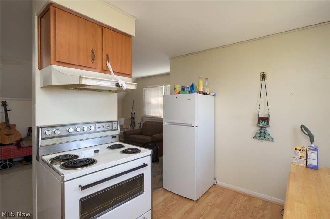 1165 Hampton Road Kent, OH 44240 - Photo 25 of 39 Kitchen with white appliances, light wood-style floors, and wood finish cabinetry