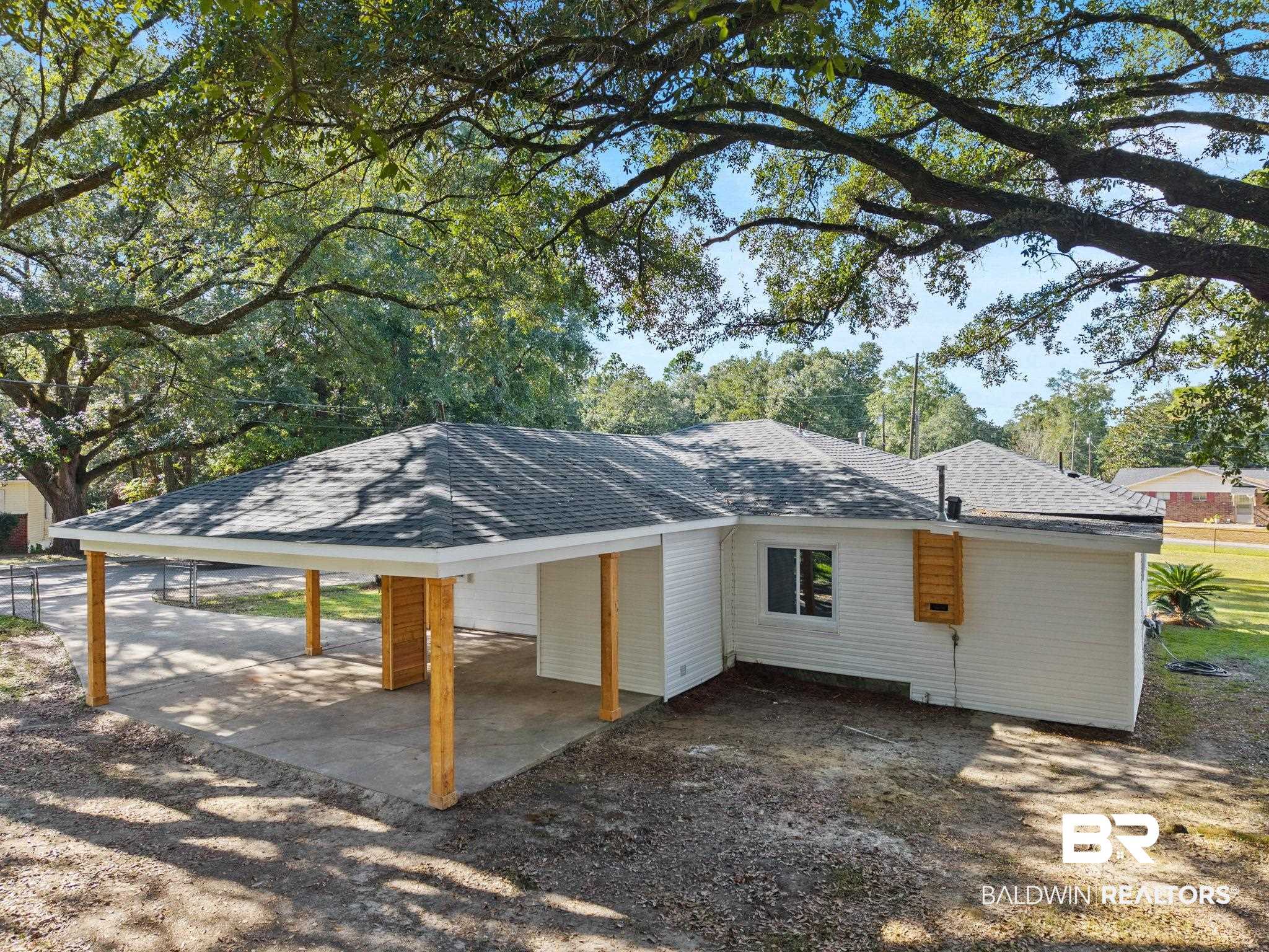618 Pine Street Saraland, AL 36571 - Photo 33 of 41 View of front of house featuring roof with shingles and a carport
