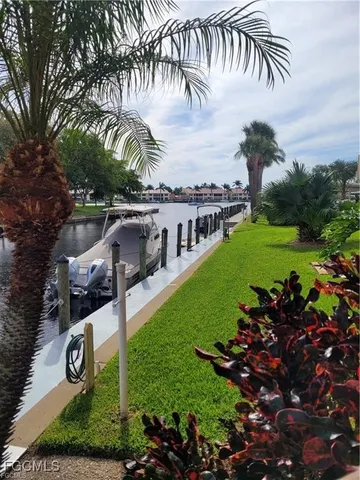 a view of a lake with couches chairs and a table