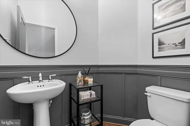 a bathroom with a sink a mirror and a toilet