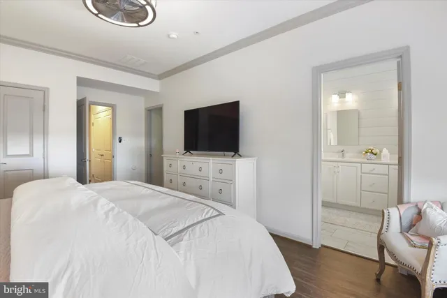 a bedroom with a flat screen tv and a bathroom