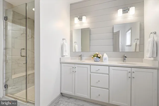 a bathroom with a double vanity sink and mirror
