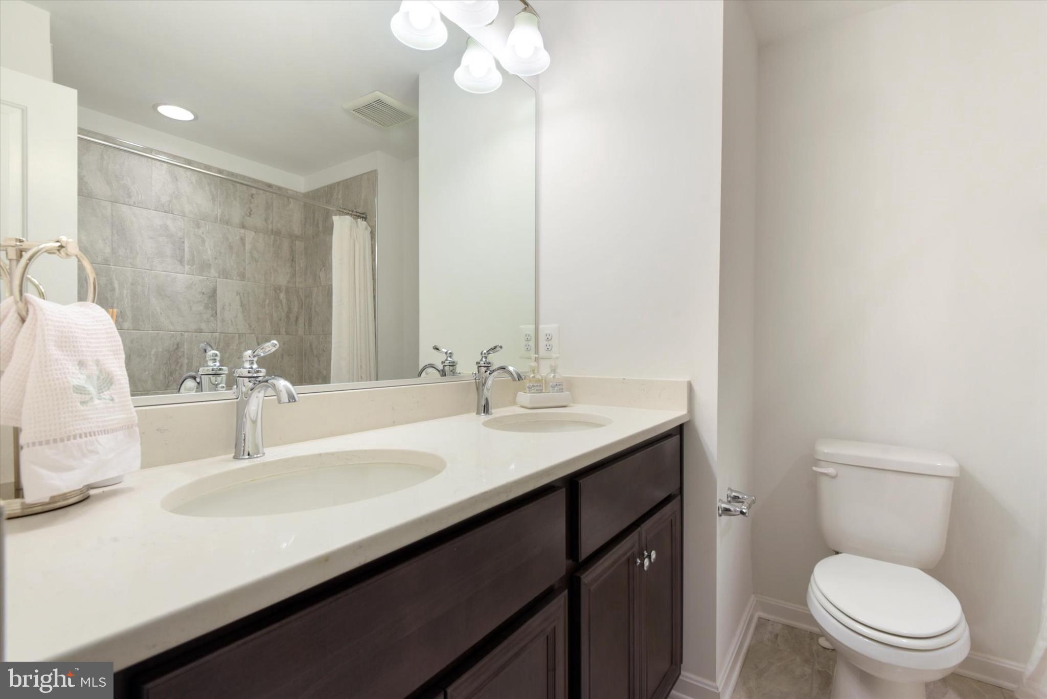 924 Lindley Road Frederick, MD 21701 - Photo 29 of 46 a bathroom with a sink a toilet a mirror and vanity