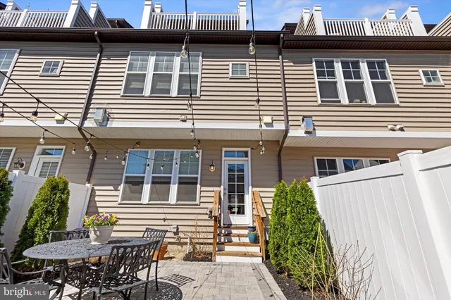 a view of a patio with table and chairs potted plants