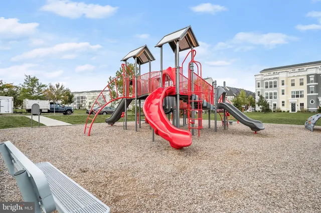a view of a park with furniture and a slide