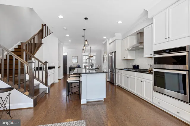 a kitchen with a sink appliances and cabinets