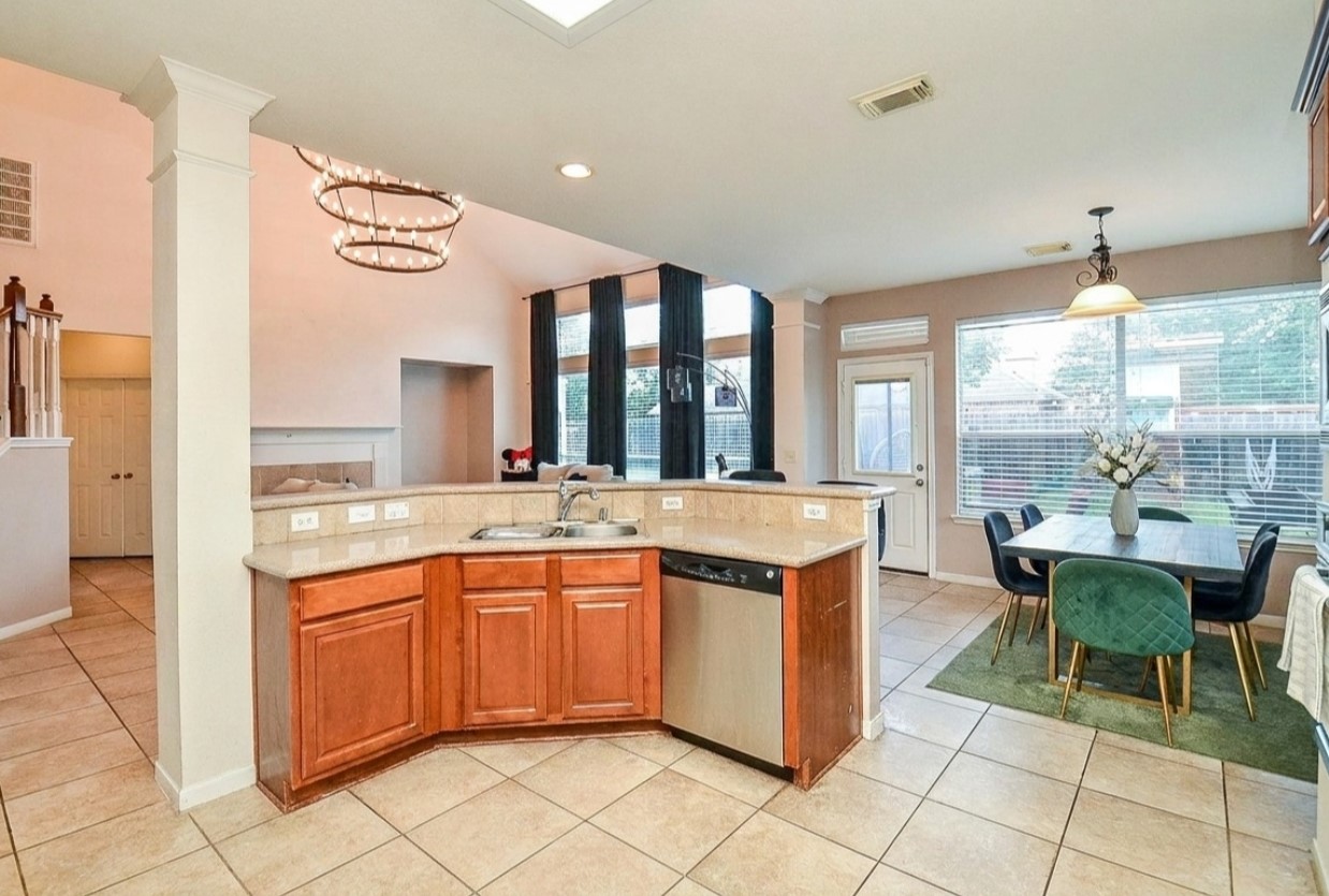 19802 Shavon Springs Drive Spring, TX 77388 - Photo 16 of 30 Modern kitchen with elegant pendant lighting, ample natural light, and a convenient open layout connecting to a cozy dining area.