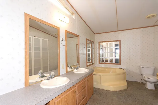 a white toilet sitting next to a bathroom sink