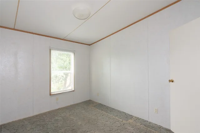 a room with walk in closet and window