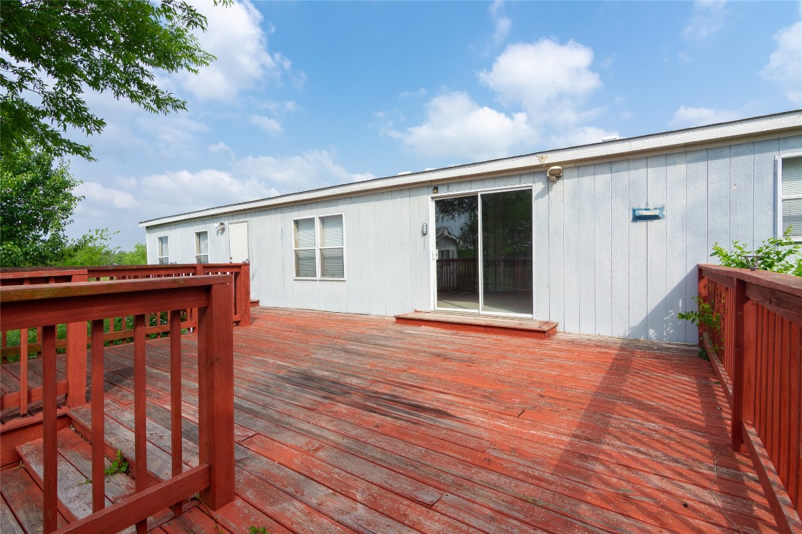 1 11209-tract Road Del Valle, TX 78617 - Photo 24 of 39 a view of a house with wooden deck and furniture