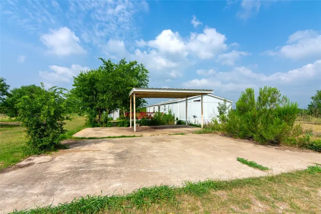 a front view of a house with yard and green space