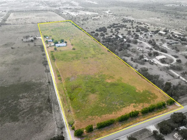 an aerial view of a house with a yard and lake view