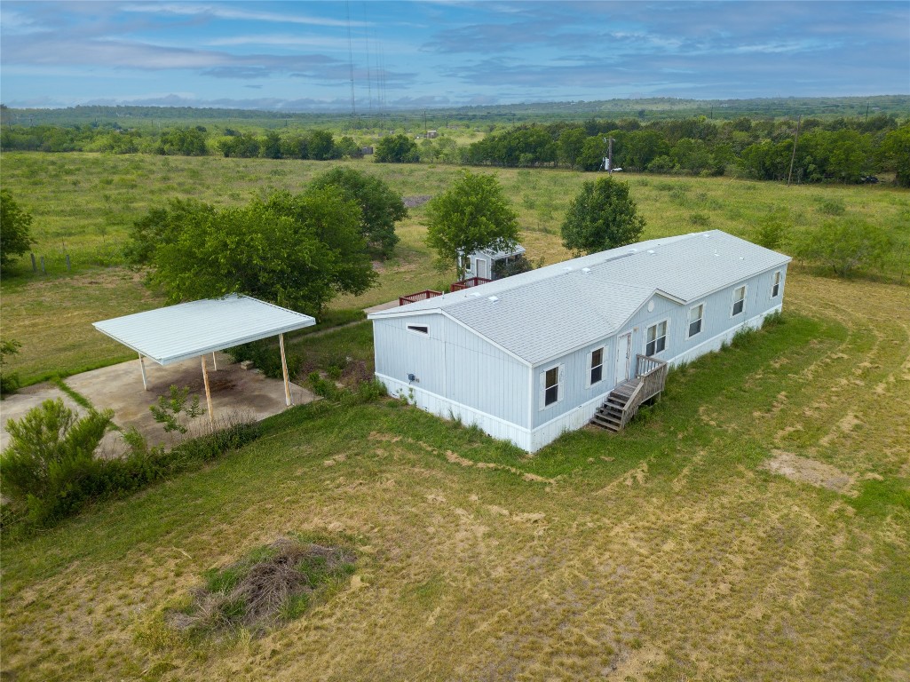 1 11209-tract Road Del Valle, TX 78617 - Photo 4 of 39 an aerial view of a house with a yard and lake view