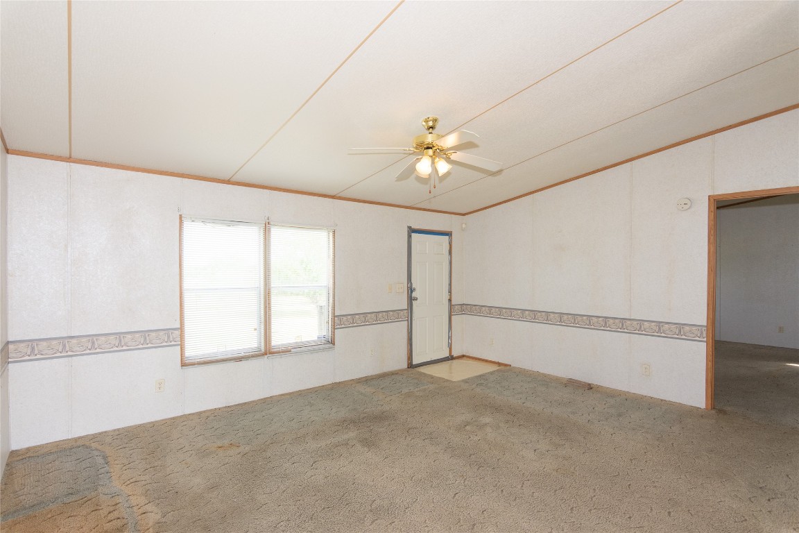 1 11209-tract Road Del Valle, TX 78617 - Photo 8 of 39 an empty room with windows and chandelier fan