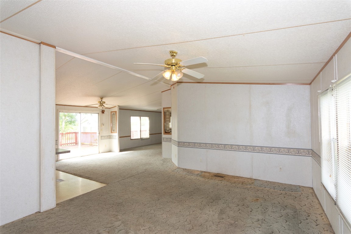 1 11209-tract Road Del Valle, TX 78617 - Photo 9 of 39 a view of a livingroom with a ceiling fan and window