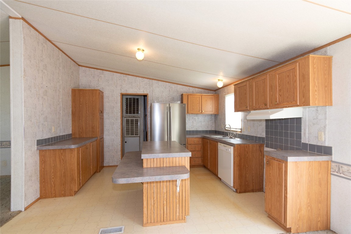 1 11209-tract Road Del Valle, TX 78617 - Photo 10 of 39 a kitchen with stainless steel appliances granite countertop a stove a sink dishwasher and a refrigerator