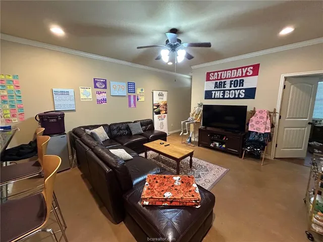 a living room with furniture a flat screen tv and a fireplace