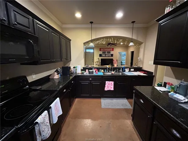 a kitchen with a stove and a refrigerator
