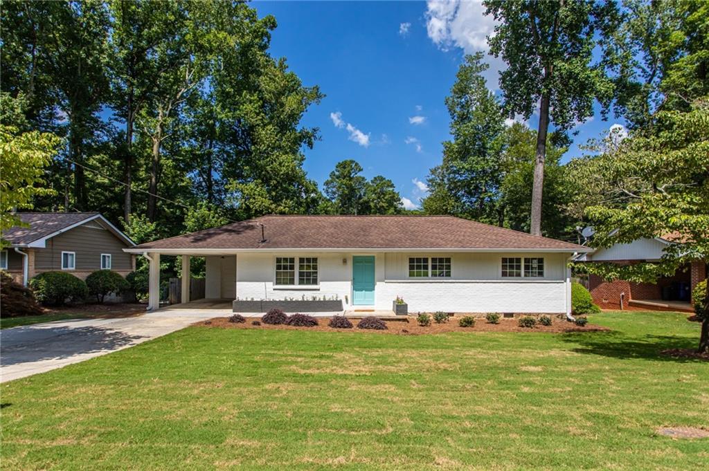 3022 Mt Olive Drive Decatur, GA 30033 - Photo 1 of 1 a front view of a house with a garden and trees