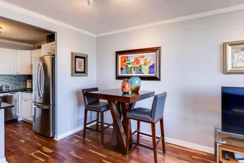 a dining room with furniture and wooden floor
