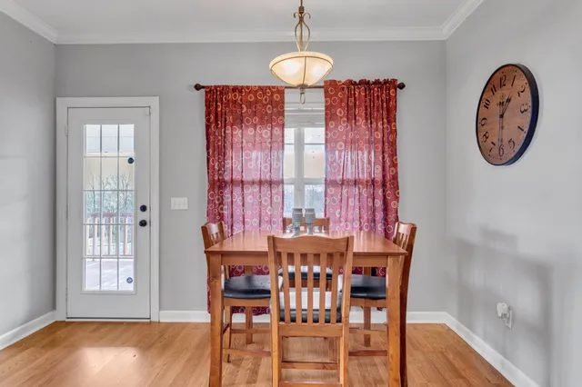 a table and chairs in a room with a window