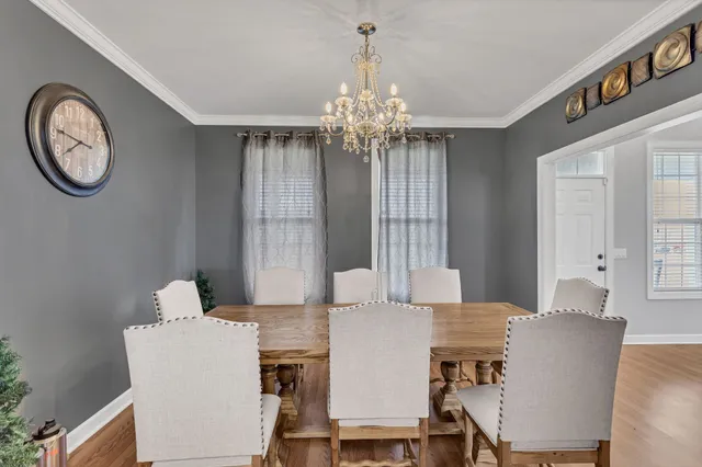 a view of a dining room with furniture and a chandelier