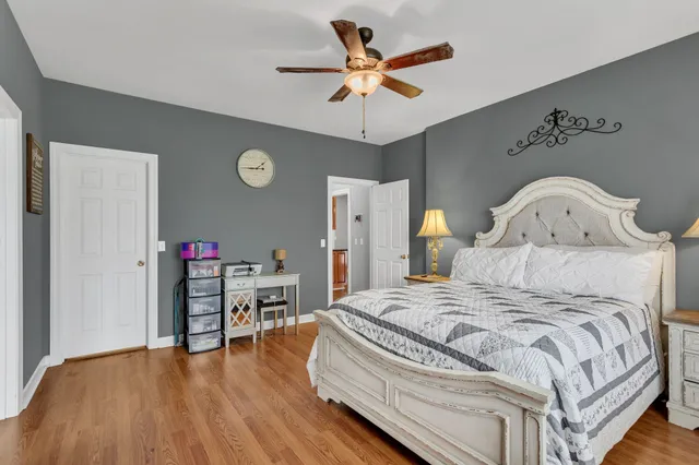 a bedroom with a bed and a chandelier