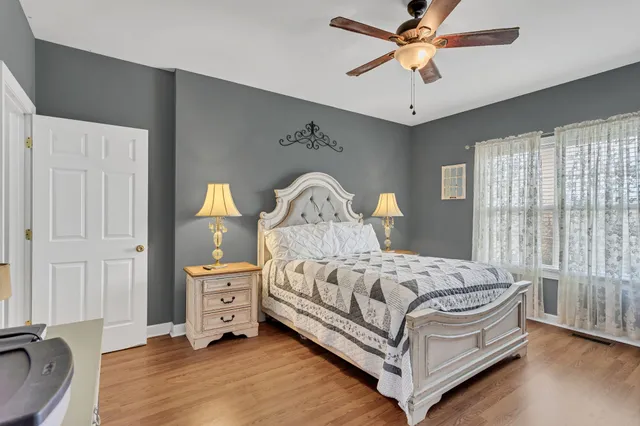 a bedroom with a bed and a chandelier