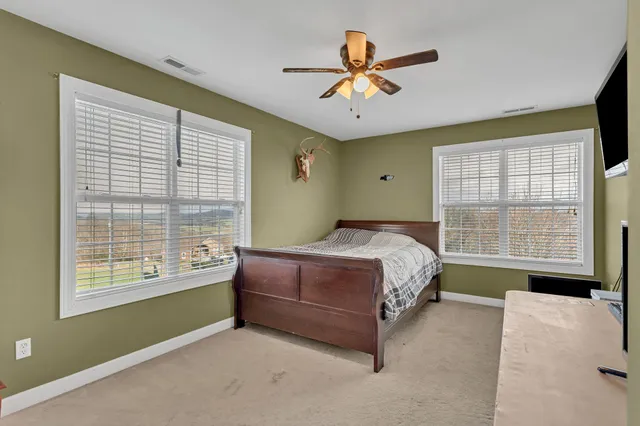a bedroom with a large bed and a large window