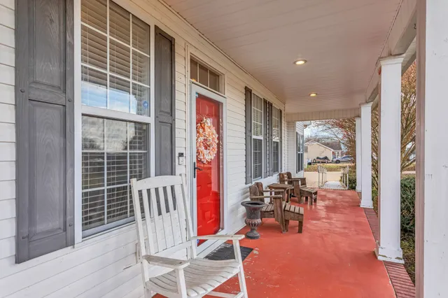 a dining room with furniture water view and large windows