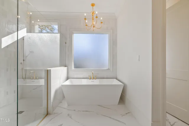 a spacious bathroom with a bathtub and shower