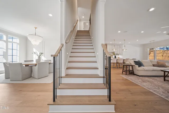 a living room with furniture and stairs