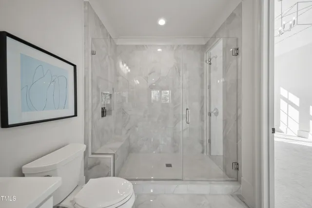 a bathroom with a shower a toilet and sink