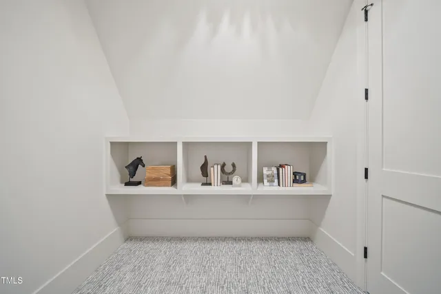 a room with a wooden floor and potted plant