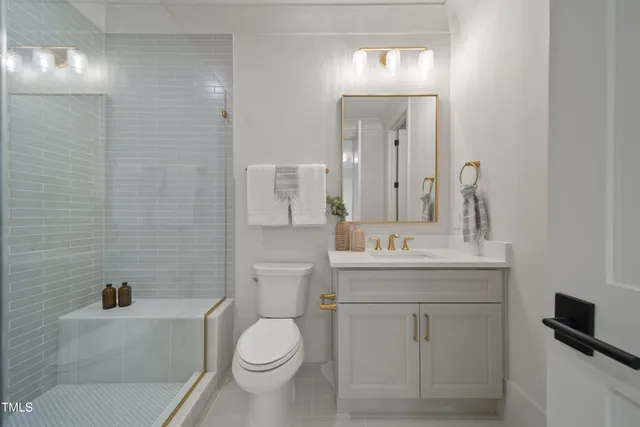 a bathroom with a sink a toilet and a mirror