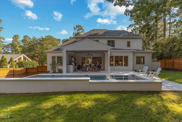 a front view of a house with swimming pool having outdoor seating
